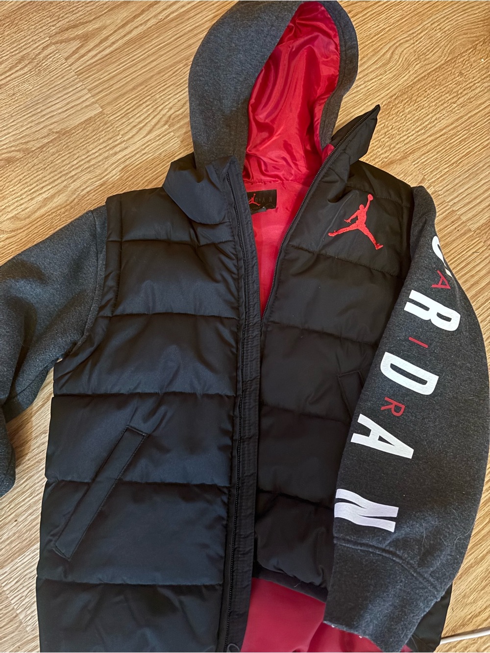 Jordan Black Puffer Jacket with Red Lining and Gray Sweatshirt Sleeves